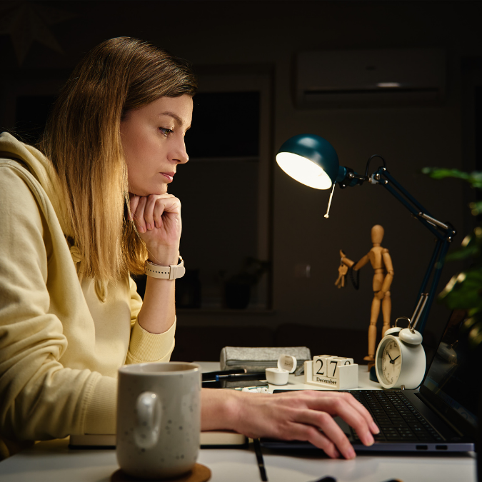 young woman on her laptop deciding whether to cancel her booking with Affordable Counselling Solutions online